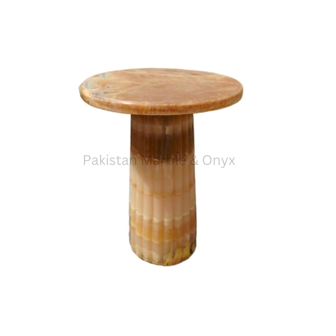 Honey Onyx Mushroom Coffee Table Marble Coffee Table luxurious mushroom-shaped coffee table made from honey onyx. The table has a warm glow and a smooth, polished surface. This coffee table is available at Pakistan Marble & Onyx.